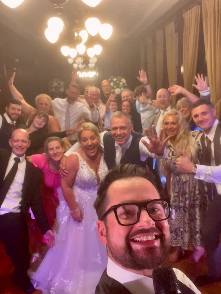 James Barlow with Wedding Party – Manchester Hall Wedding DJ & Singer - James Barlow - Wedding Singer James Barlow with the wedding party at Manchester Hall after providing live music and DJ entertainment for a wedding celebration